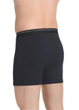 Black boxer briefs worn by a person on a light gray background