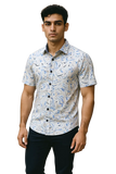 Man wearing a patterned shirt on a white background