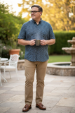 man standing with short sleeve shirt from American heritage with small multi colored pattern