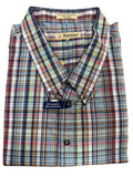 Folded plaid shirt with brand labels on a wooden surface