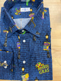 A folded long-sleeve button-up shirt with a blue brick-patterned base and colorful Mardi Gras themed illustrations, including street lamps, balloons, and a 'Mardi Gras' graphic, displayed on a light wood surface.