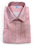 Folded pink patterned shirt on a white background
