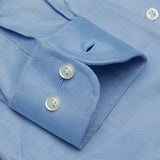 Close-up of a blue shirt with buttons and collar