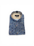 Folded blue patterned shirt on a white background