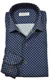 Folded blue patterned shirt with a visible brand label on a white background