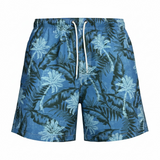 Blue tropical leaf patterned shorts on a white background