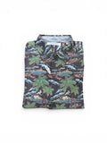 Folded shirt with a tropical pattern on a white background