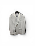 White tuxedo jacket on a hanger against a white background