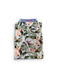 Roll-up sleeveless shirt with tropical leaf pattern on a white background