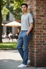 Man leaning against a brick wall in an outdoor setting