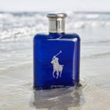 Blue Ralph Lauren cologne bottle on a sandy beach