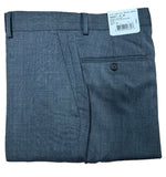 Folded gray pants with a tag on a wooden surface