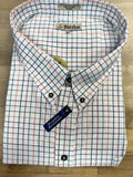 Folded checkered shirt with brand labels on a wooden surface