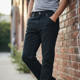 male leaning against brick wall wearing black stretch twill pants form grand river