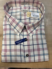 Plaid shirt with visible brand labels on a wooden surface