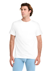 Man wearing a plain white t-shirt and light blue pants on a white background