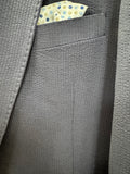 Close-up of a textured navy fabric with a small patterned label.