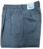 Folded gray pants with a tag on a wooden surface