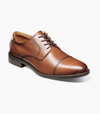 Brown leather dress shoe on a white background
