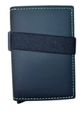 A black leather SEORID card holder wallet with light green stitching and a black elastic band closure, shown on a light wood background.