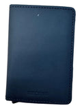 A black leather Secrid cardholder wallet with visible stitching and the brand name debossed at the bottom, resting on a light wood grain surface.