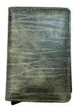 A dark olive green textured leather wallet with 'SECRID' debossed on the front, resting on a light-colored wooden surface.