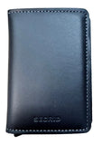 A black leather Secrid wallet with visible stitching and an embossed logo, resting on a light wood grain surface.