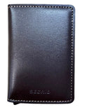 A dark brown leather card holder wallet with white stitching and an embossed 'SEORIO' logo, placed on a light wood grain surface.