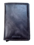 A dark chocolate  leather passport cover or wallet with visible stitching and the debossed brand name 'SECRID' near the bottom, placed on a light wood grain surface.