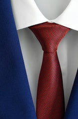 Red patterned tie on a mannequin with a white shirt and cobalt blue suit at lil johns
